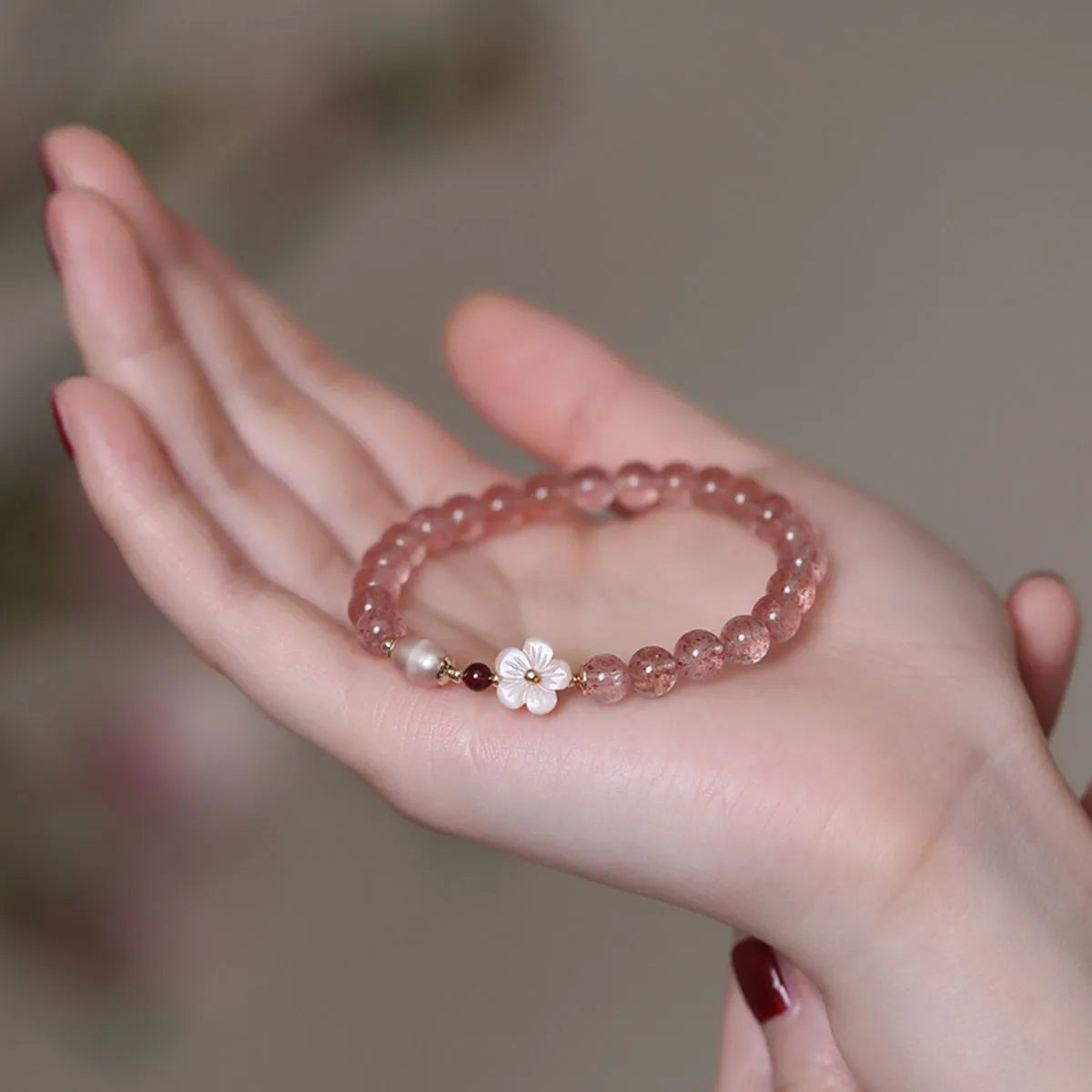 Strawberry quartz peach blossom bracelet with crystal flower design and adjustable fastening