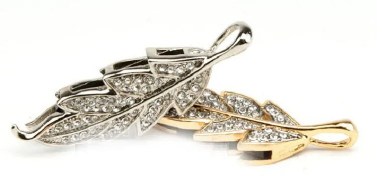 Silver metal USB flash drive with crystal leaf jewellery design on a white background.
