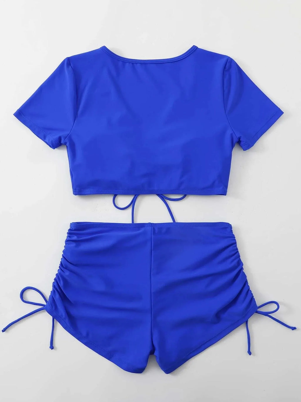 Women's two-piece lace-up bow swimsuit set in dark green, showing top and shorts.