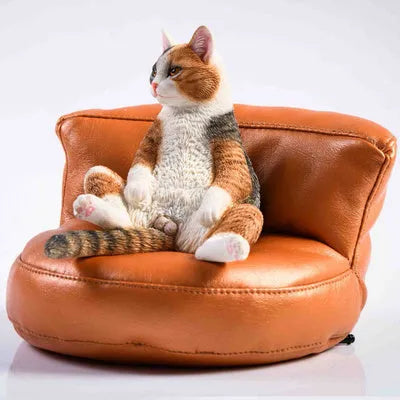 Lazy cat car ornament with sofa, a 7.5cm high resin dashboard decoration figurine.
