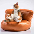 Lazy cat car ornament with sofa, a 7.5cm high resin dashboard decoration figurine.
