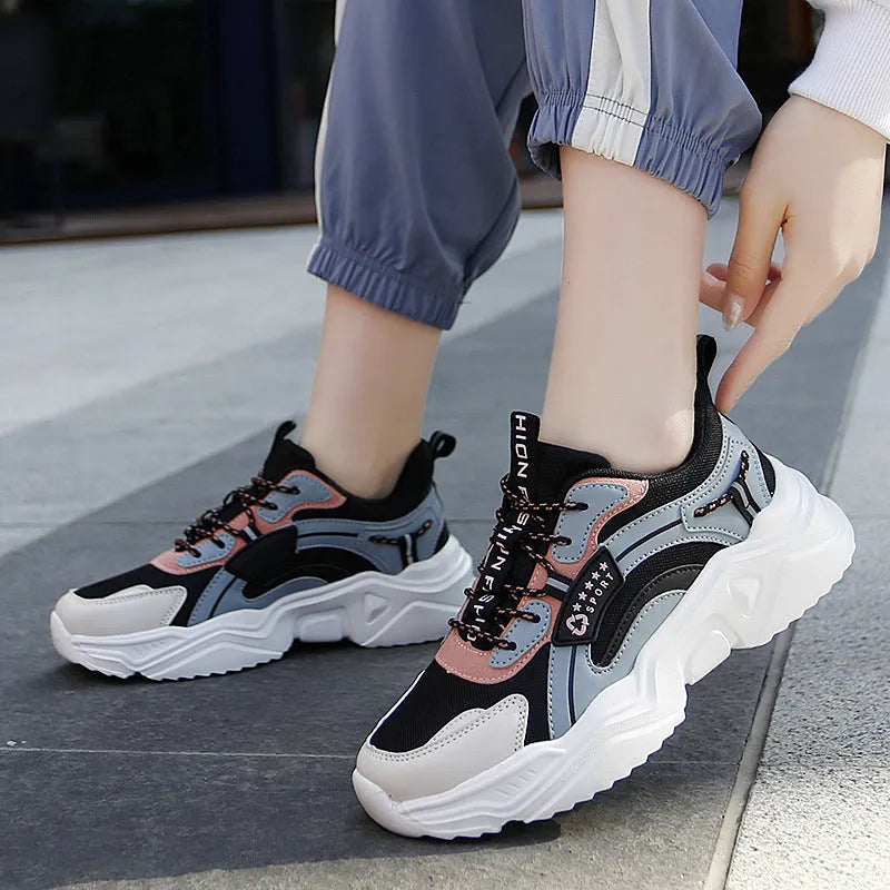 Women's white casual sports shoes with mesh upper, thick PU sole, buckle detail, and round toe.
