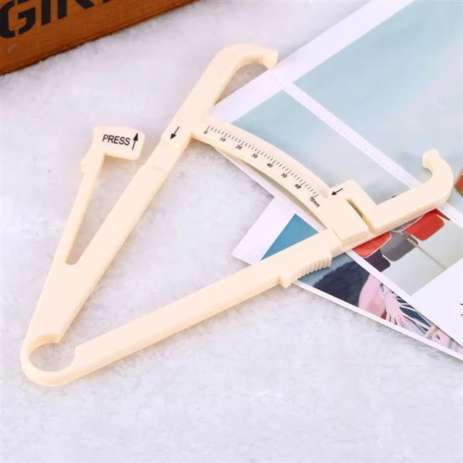 Clear acrylic body fat caliper showing measurement scale up to 200mm with sebum clamp design