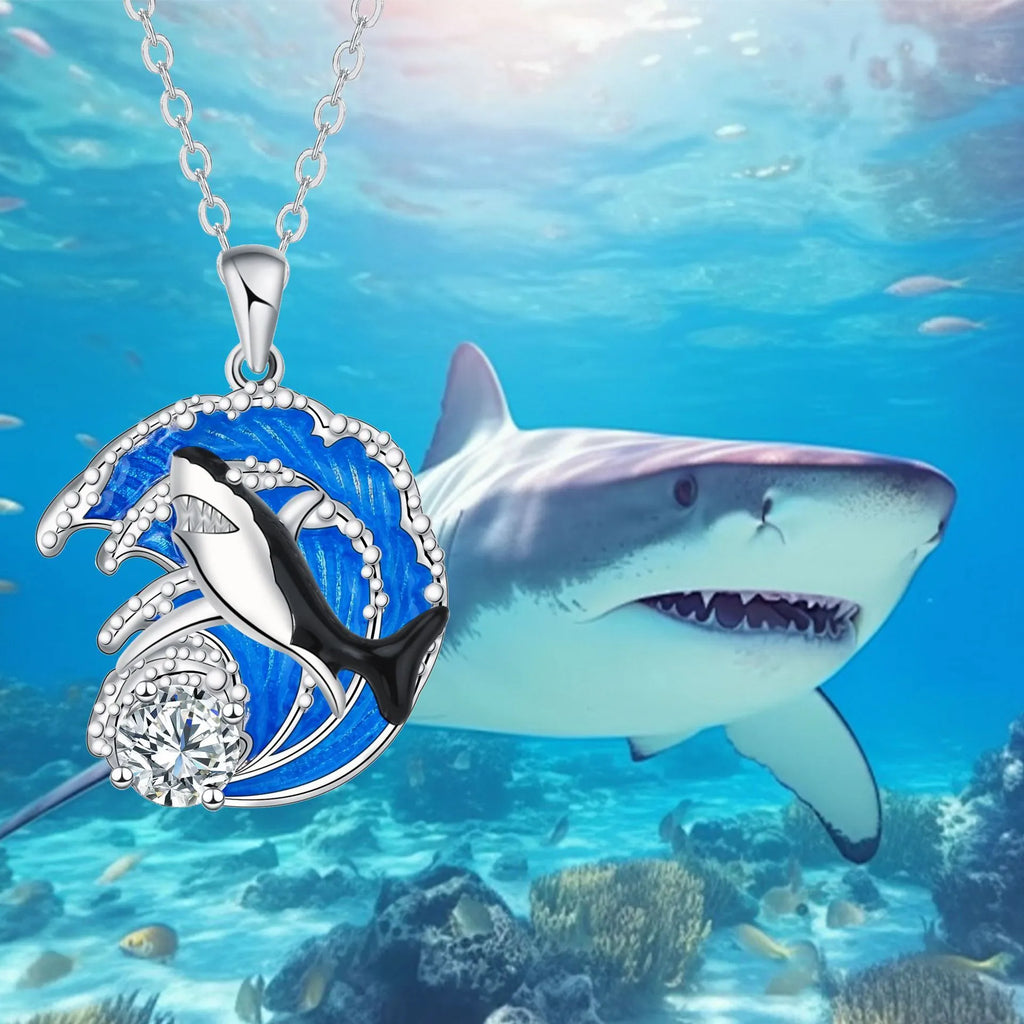 Silver shark pendant necklace on a cross chain, adjustable between 41cm and 50cm.