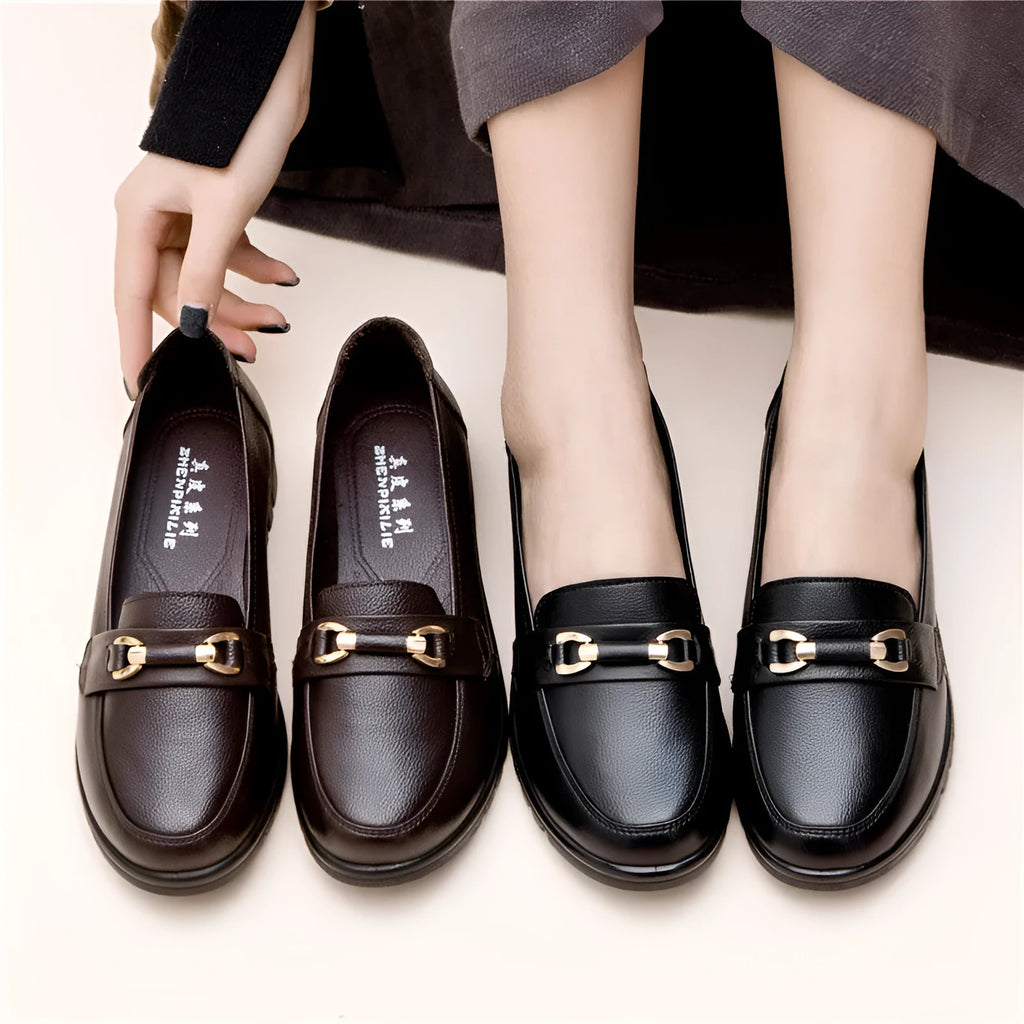 Black women's casual slip-on pumps with a round toe, low heel, and metallic detail.