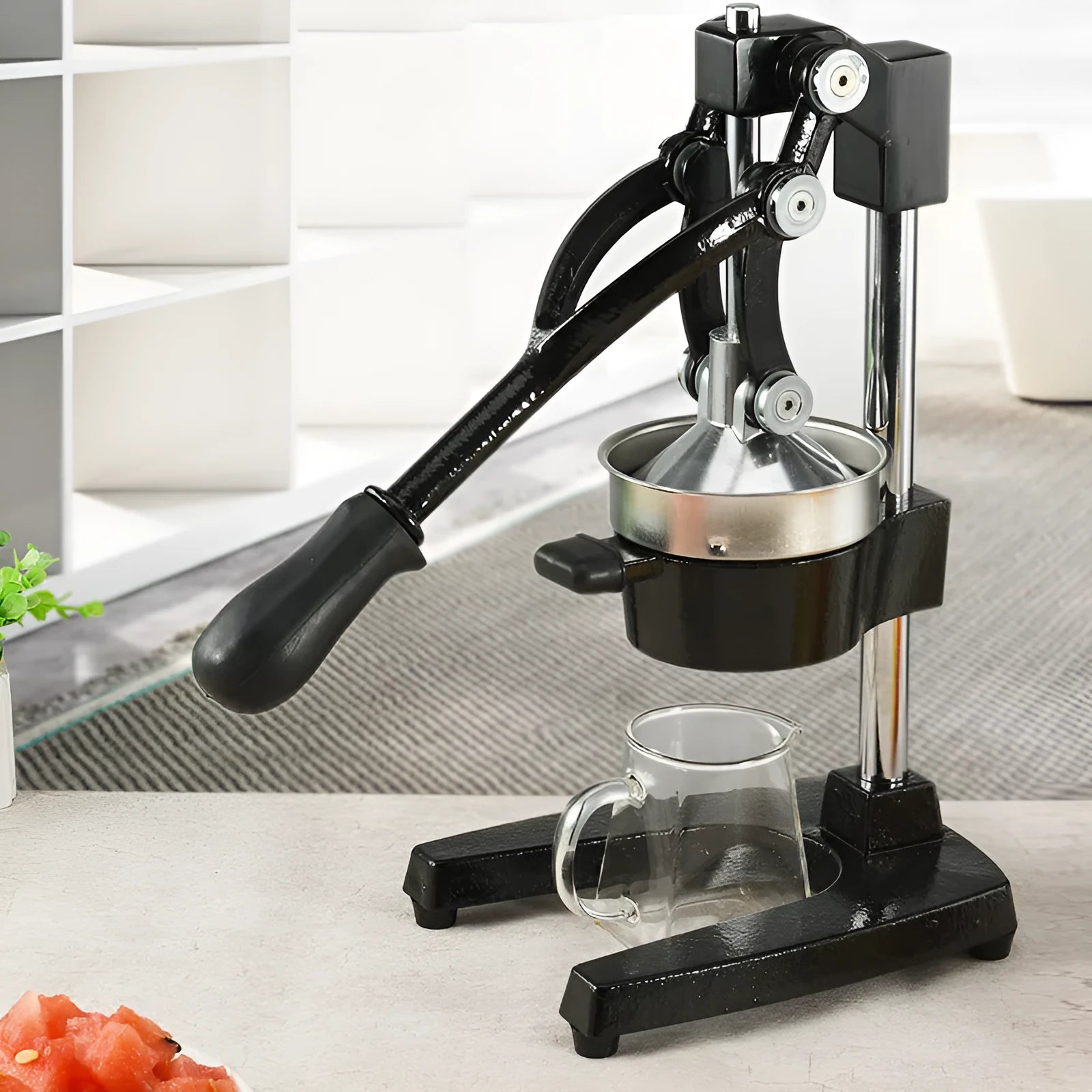Black cast iron manual juicer with stainless steel strainer measuring 40cm in height