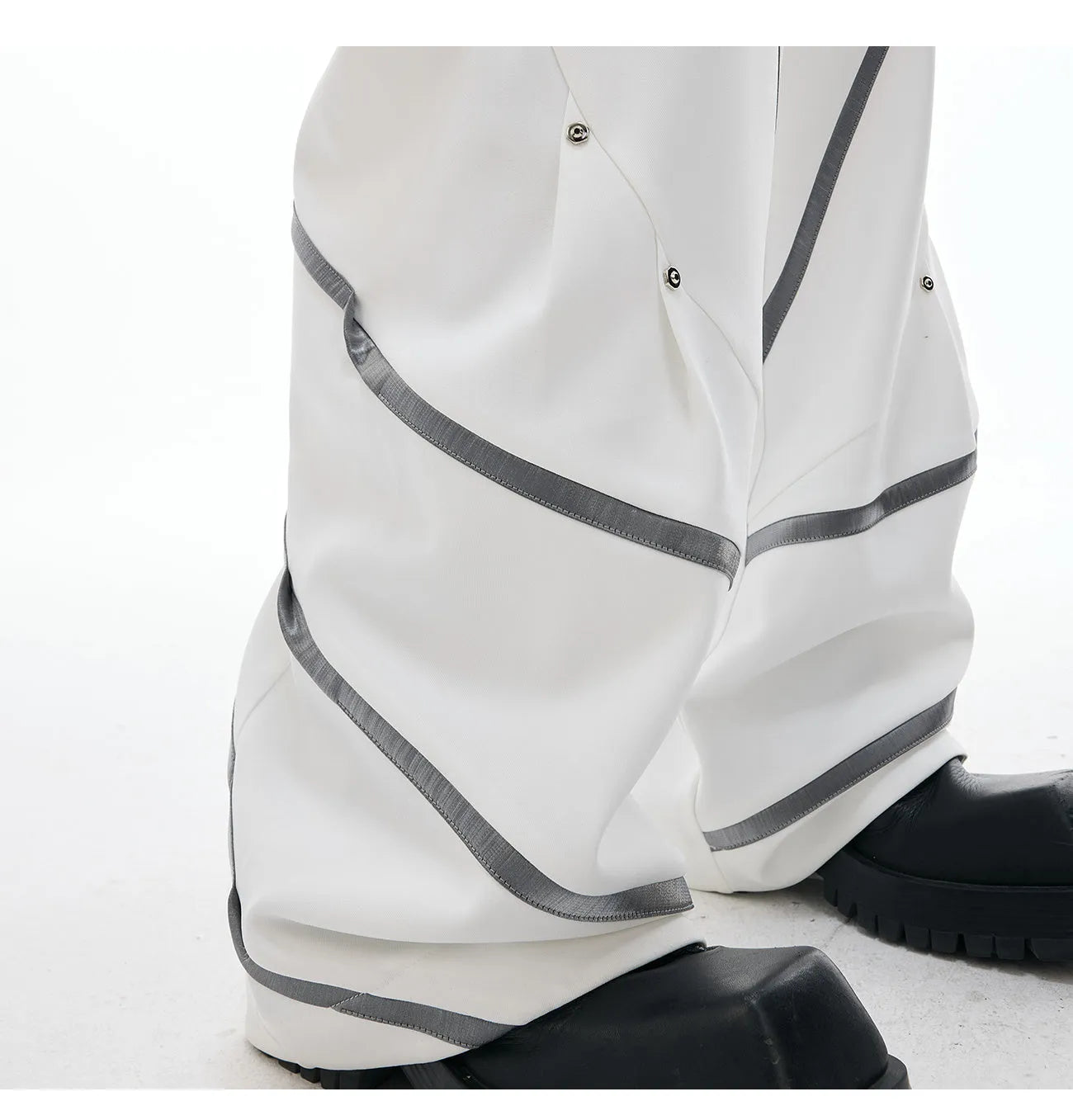 Men's black trousers with metal striped rivets and pleated design detail
