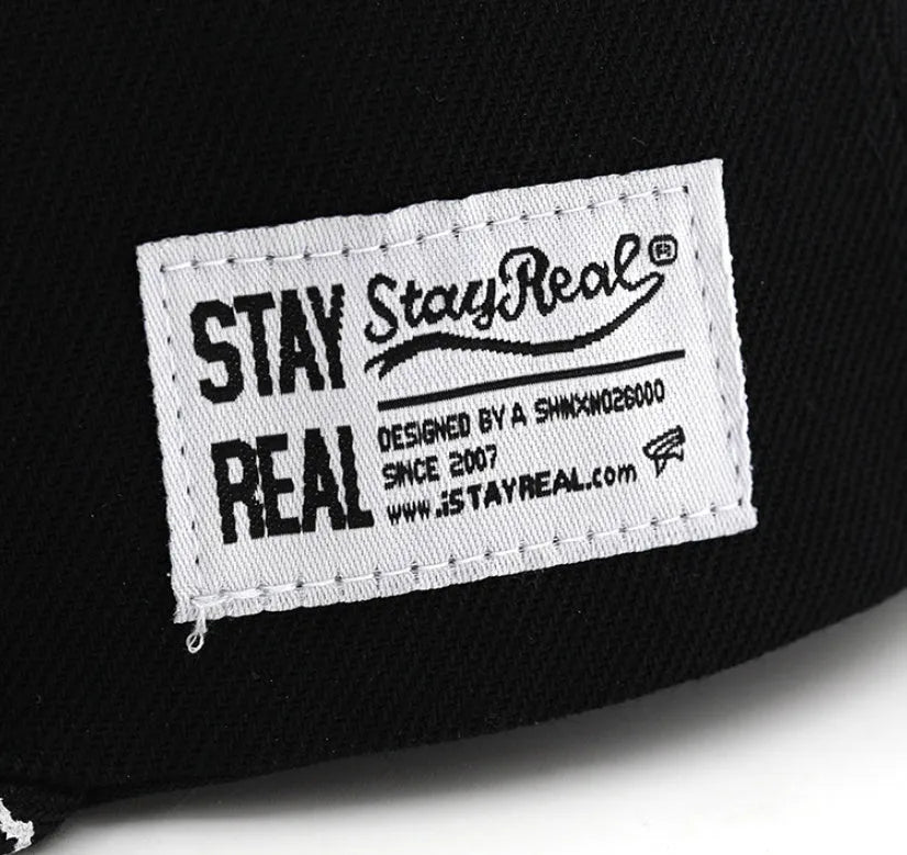 Cotton baseball hat with front letter embroidery in black colour, showing adjustable strap and dome crown.