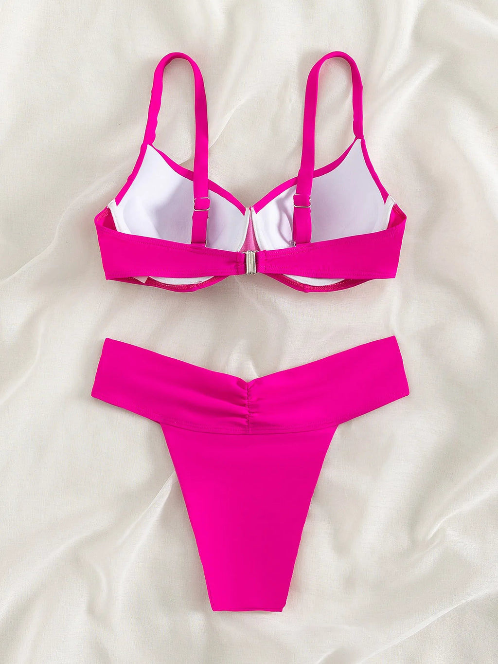 Women's solid colour nylon bikini swimsuit in fluorescent pink on a mannequin.