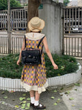 Black college style messenger bag for women made from oil wax leather-look PU material.