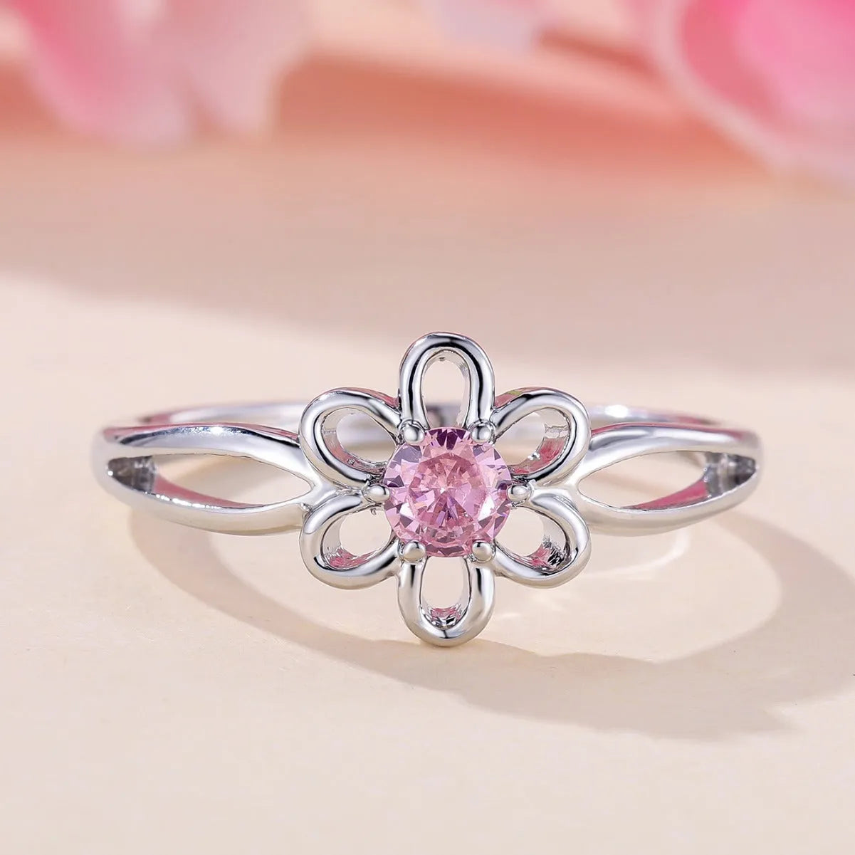 Women's hollow floral fashion ring in copper with electroplated finish, shown in platinum pink diamond colour.