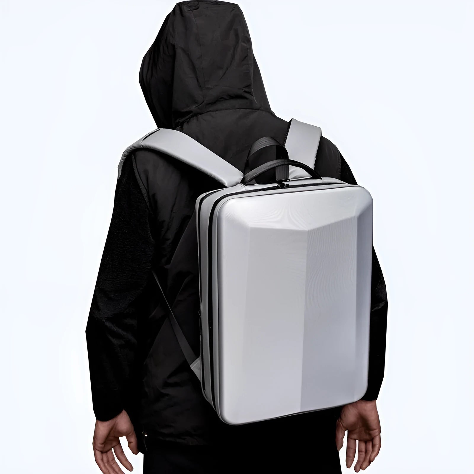 Black waterproof ABS PC business backpack with a curved shoulder strap, shown next to a laptop.