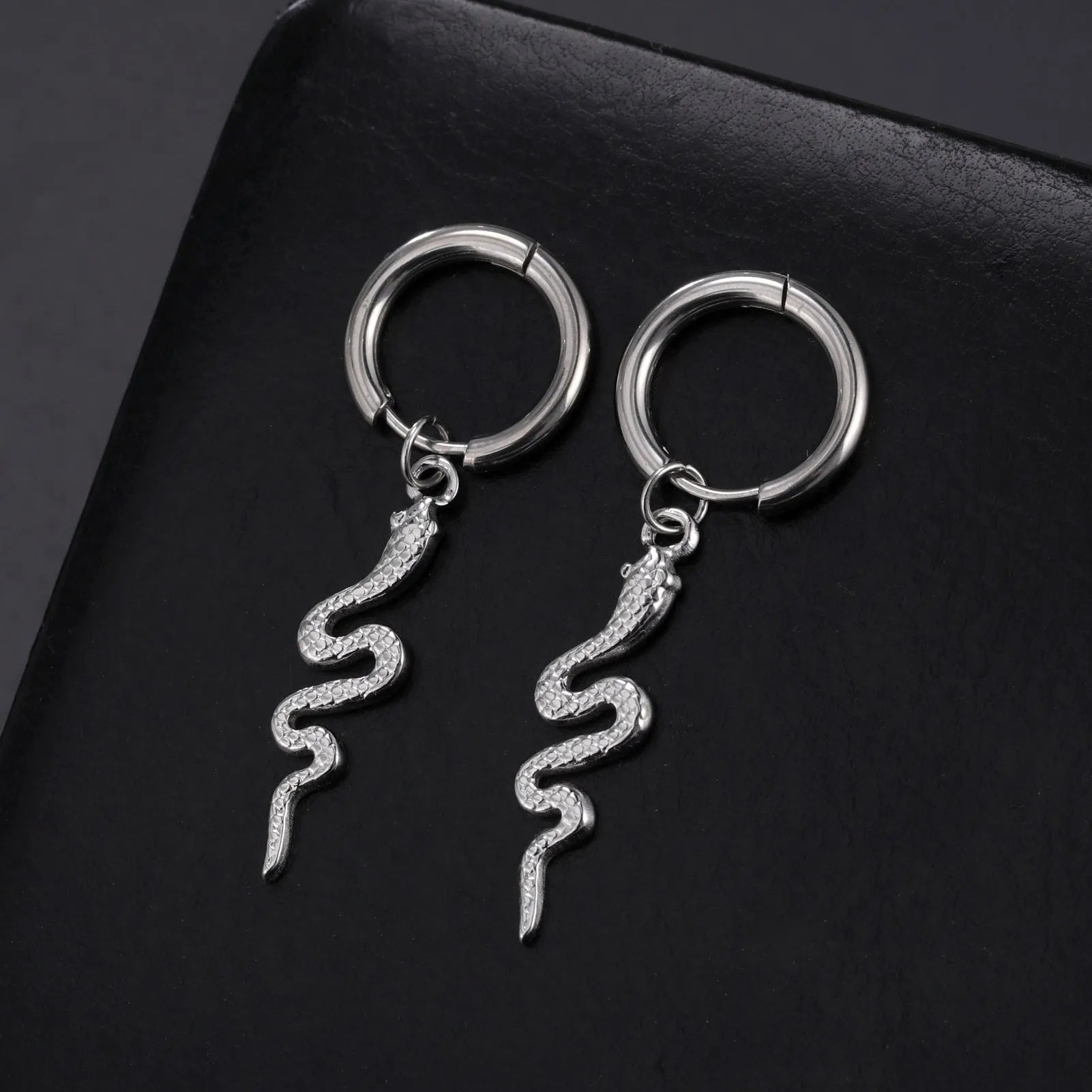 Vintage snake-shaped stainless steel earrings with gold plating in an ear clip design.