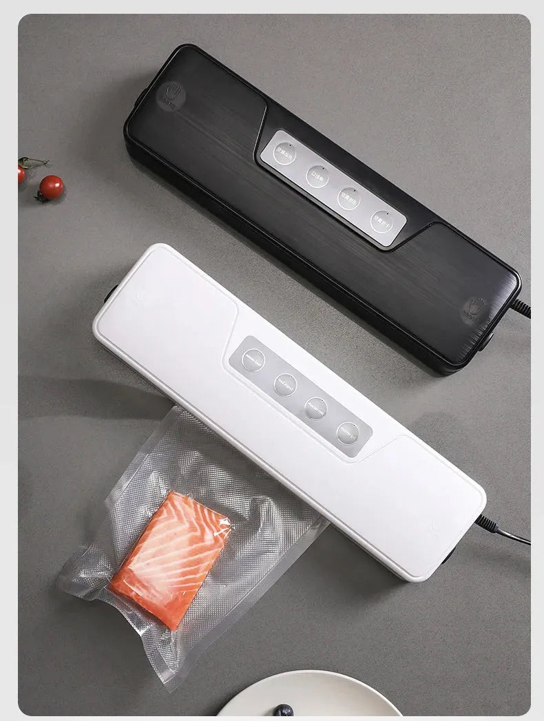 Small white automatic vacuum sealer machine for home food preservation on a kitchen counter.