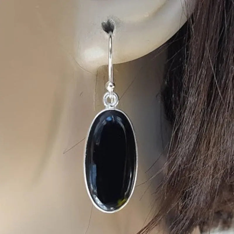 Black women's earrings with an oval black agate pendant on 925 silver, in a Chinese geometric style.