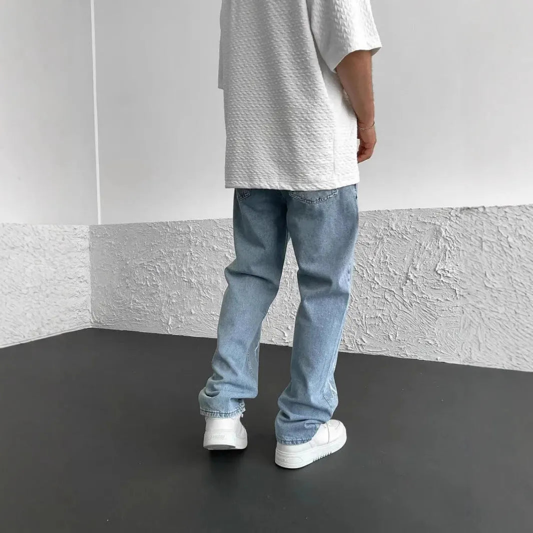 Blue men's straight-leg denim jeans with a loose wide-leg fit and mid-rise waist.