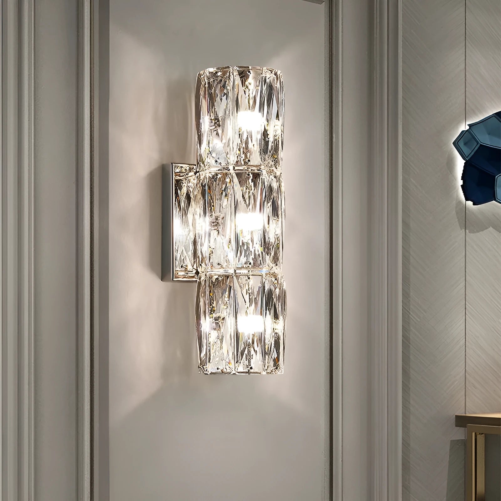 Crystal wall lamp with stainless steel base in chrome finish, LED light source