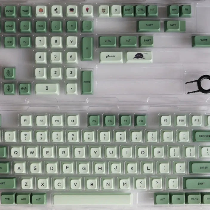 Full set of 124 matcha green PBT keycaps for a mechanical keyboard, showing various international layout options.