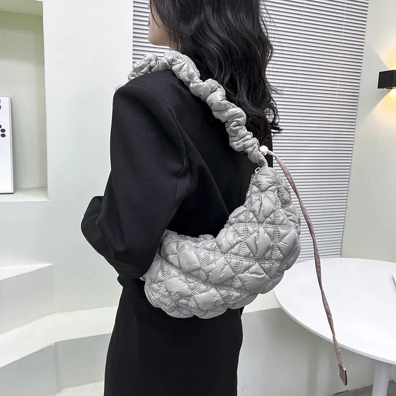 Beige nylon women's casual shoulder messenger bag with a long strap, shown from the side.