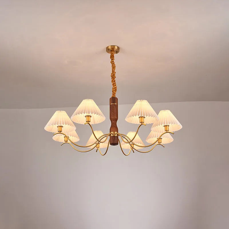 Retro wooden wall lamp with fabric shade in walnut finish mounted beside a bed.