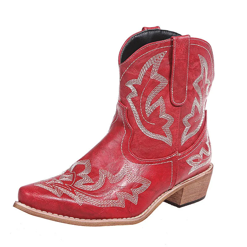 Women's blue cowboy boots with wedge heel, pointed toe, and embroidery details on low canister.