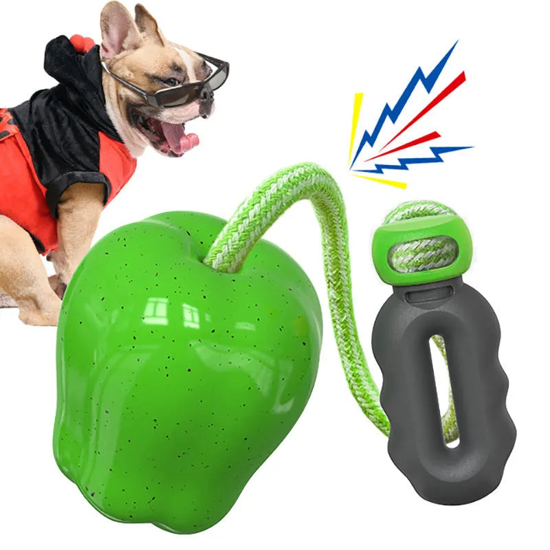 Green plastic dog chewing toy with dropping ball design for food dispensing