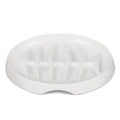 Green melamine fishbone slow feeder bowl for cats with raised ridges on a plain background