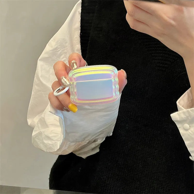 Silicone AirPods case with holographic laser ring design, shown next to AirPods Pro 2 and AirPods 3.