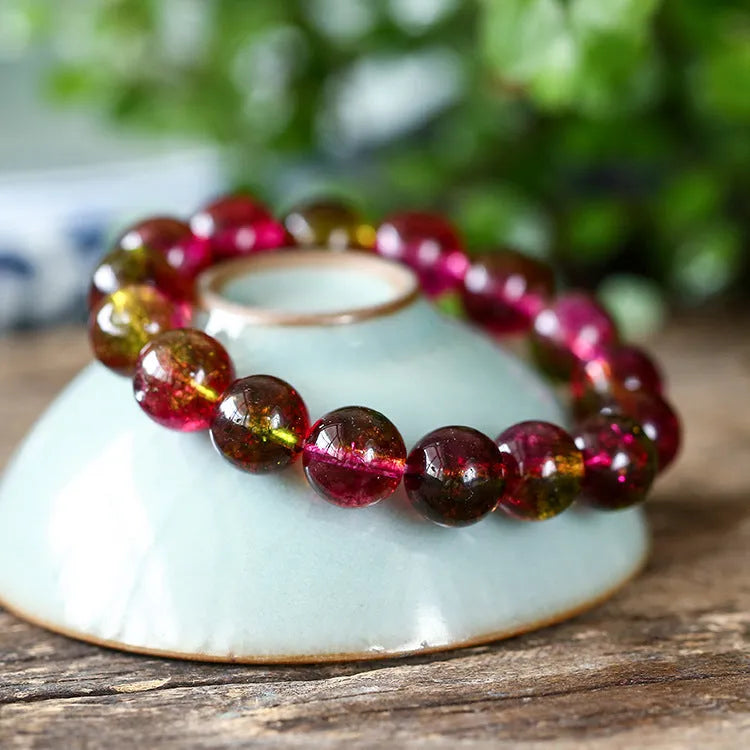 Handmade women's bracelet with red and green watermelon crystal beads on a string.