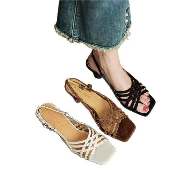 Retro women's sandals with thin cross straps, ankle buckle, and a mid heel in light brown.