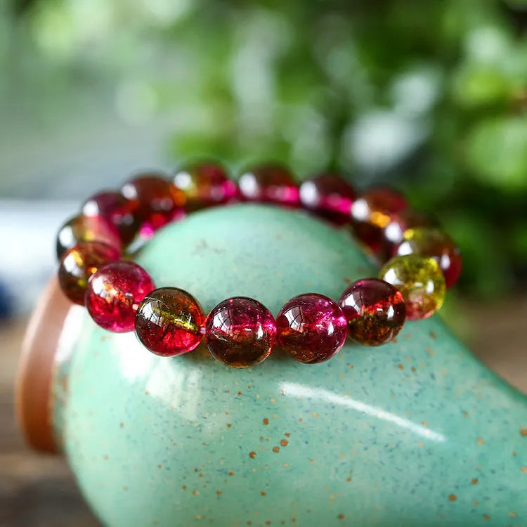 Handmade women's bracelet with red and green watermelon crystal beads on a string.