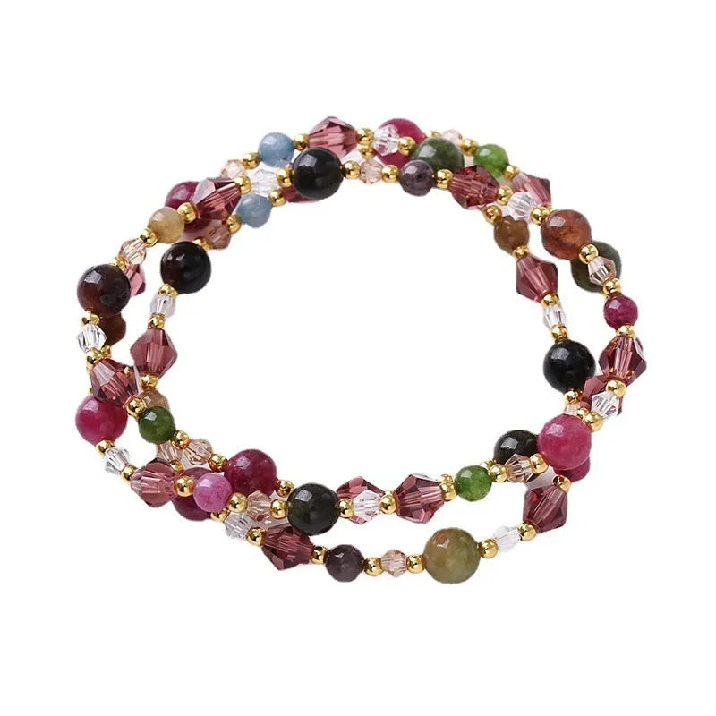 Women's three-ring bracelet with tourmaline, strawberry quartz, and amethyst crystals on an adjustable rope.