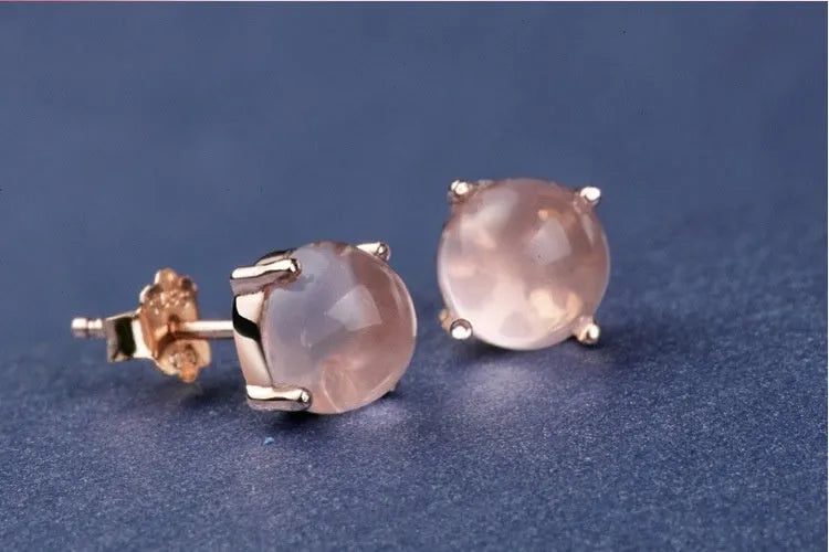 Rose gold coloured drop-shaped stud earrings with a synthetic ross quartz crystal inlay