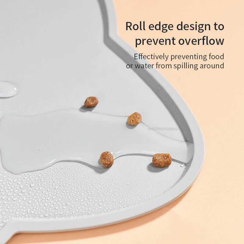 Blue silicone pet feeding mat under food and water bowls measuring 44 by 24 centimetres