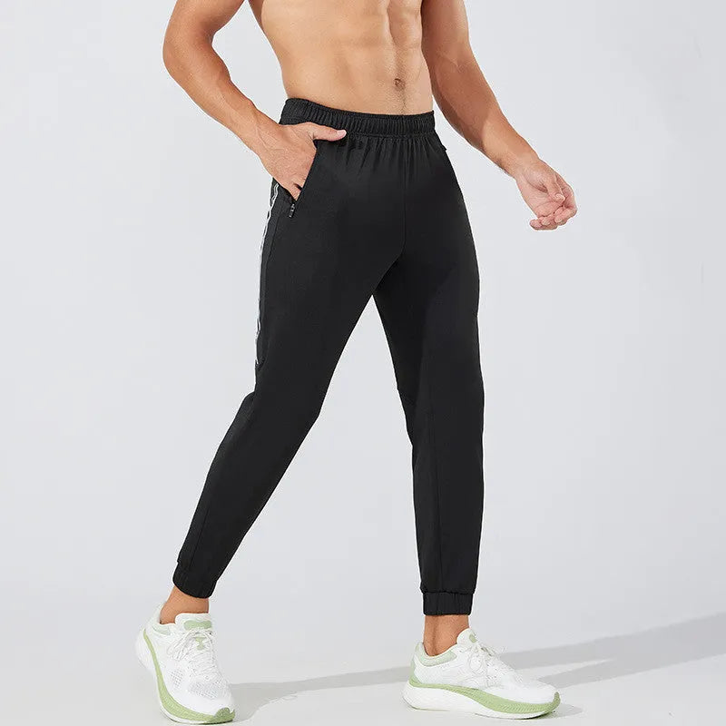 Men's black running trousers with mid waist design and polyester construction