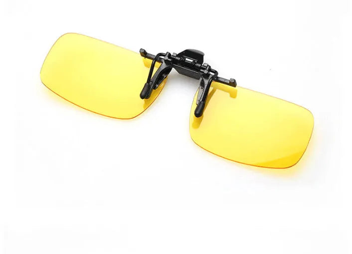 Clip-on night vision polarised sunglasses attached over a pair of prescription glasses for driving.