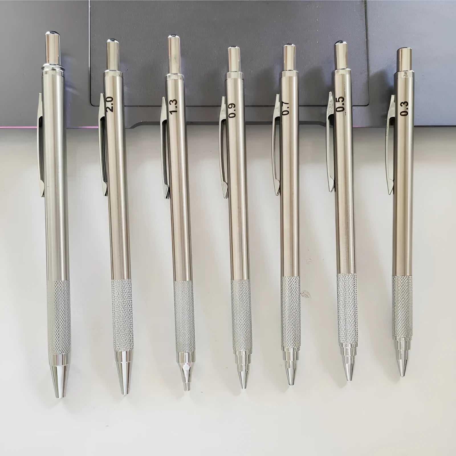 Metal automatic mechanical pencil showing five available lead diameter options from 0.5mm to 2.0mm