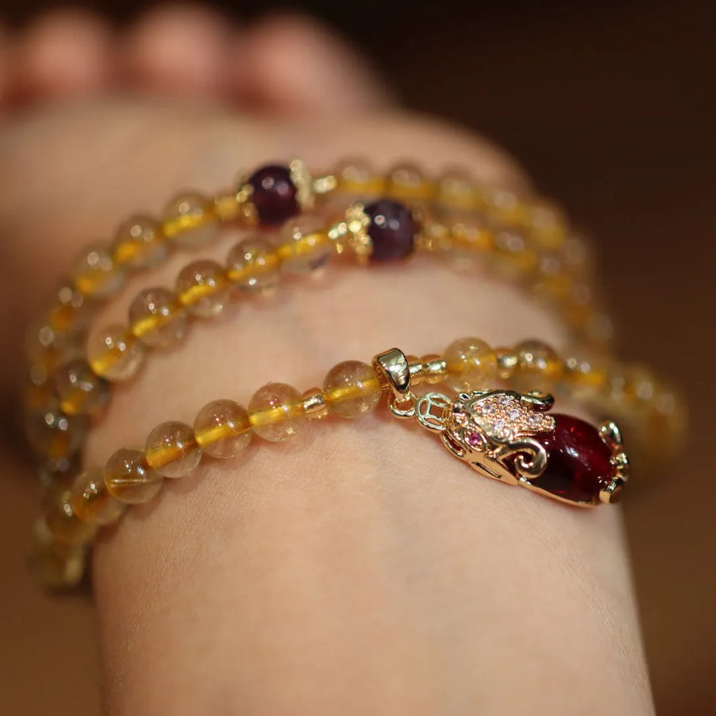 Brazil gold rutilated quartz bracelet with three golden circles and ruby quartz hanging chopsticks