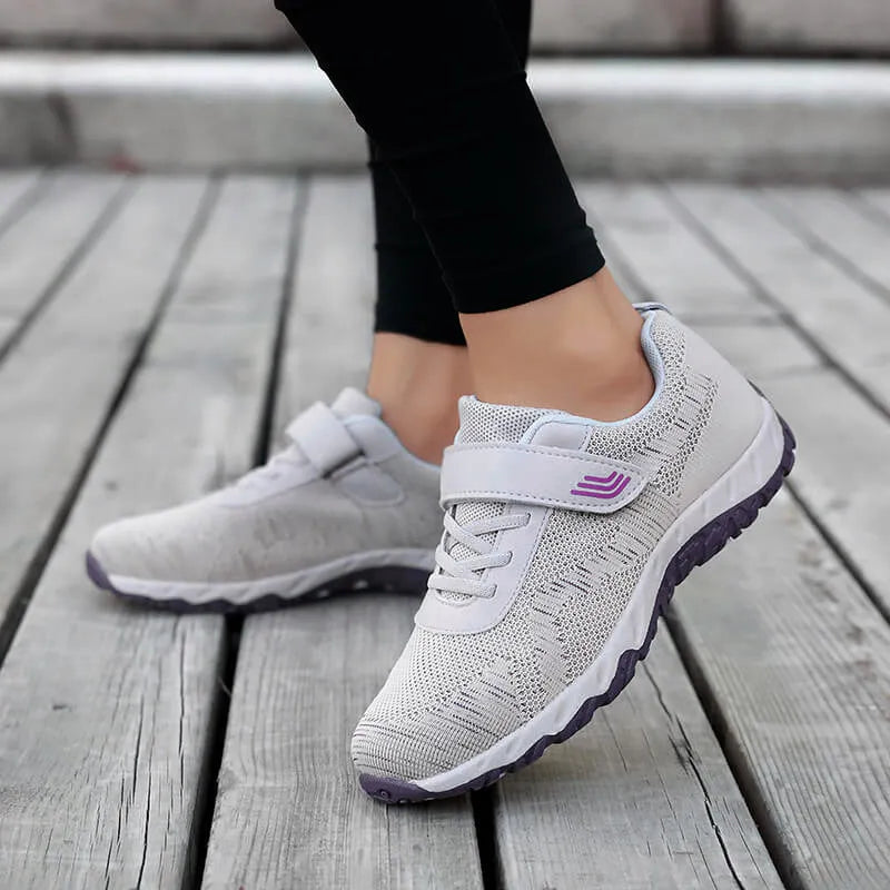 Women's grey purple breathable mesh shoes with a velcro strap and wedge heel on a composite sole.