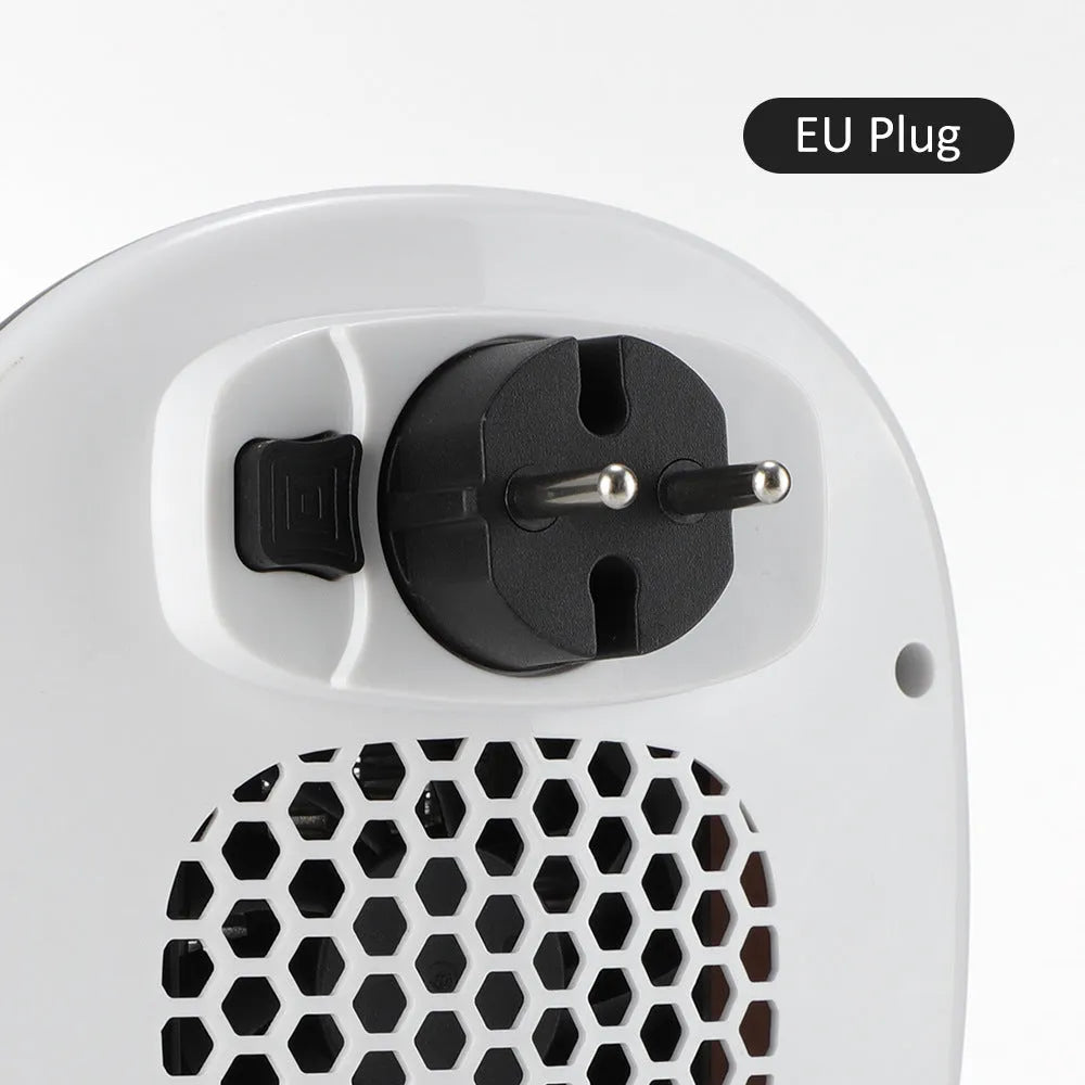 White ceramic portable electric heater with remote control on a table.