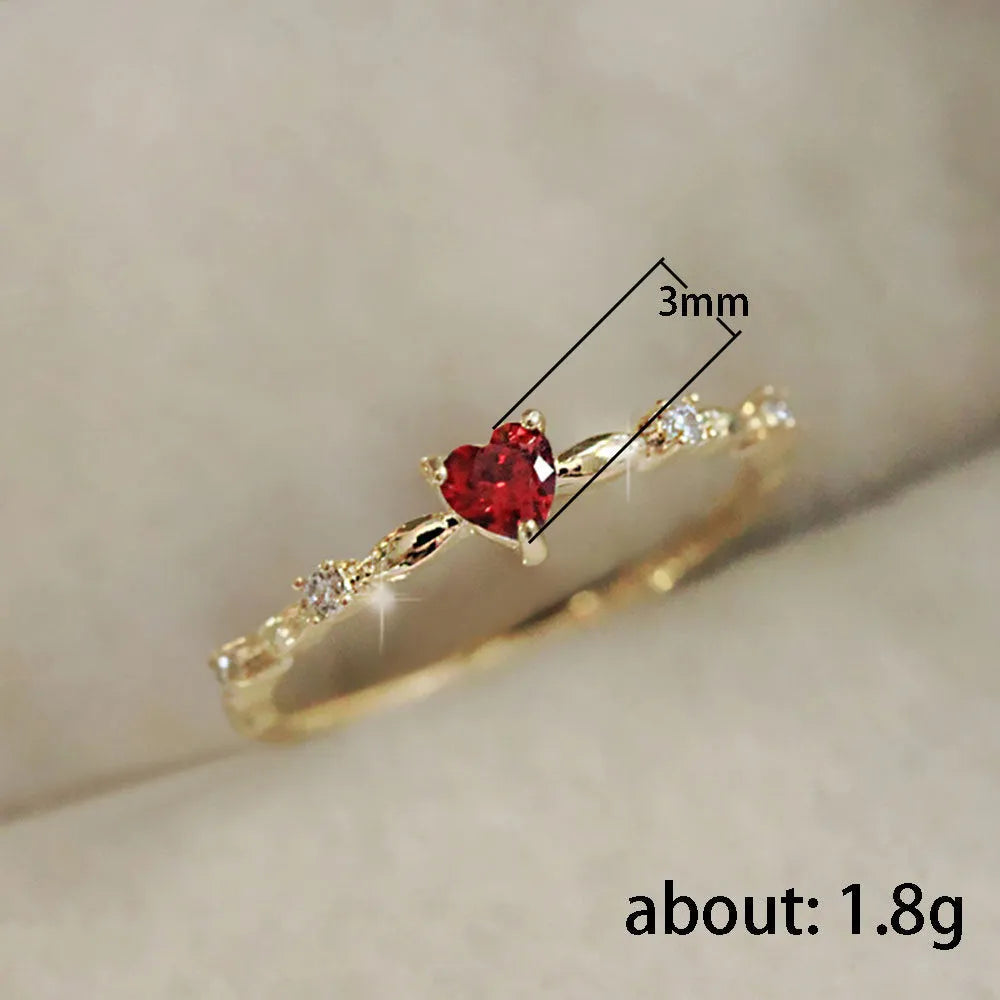 Gold electroplated copper ring with a peach heart charm and set zircon stone.