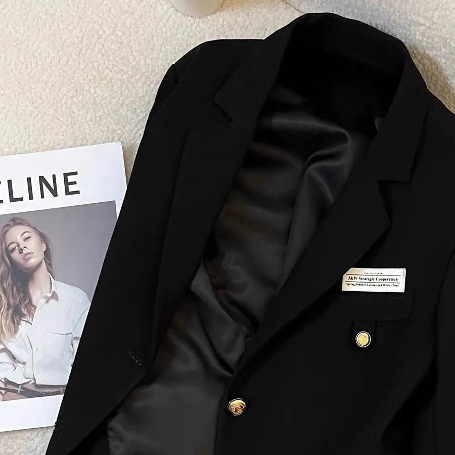 Black women's loose-fit suit coat with long sleeves and pockets for college and commute wear.