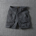 Men's cotton cargo shorts in army green with multiple pockets and straight-leg cut.