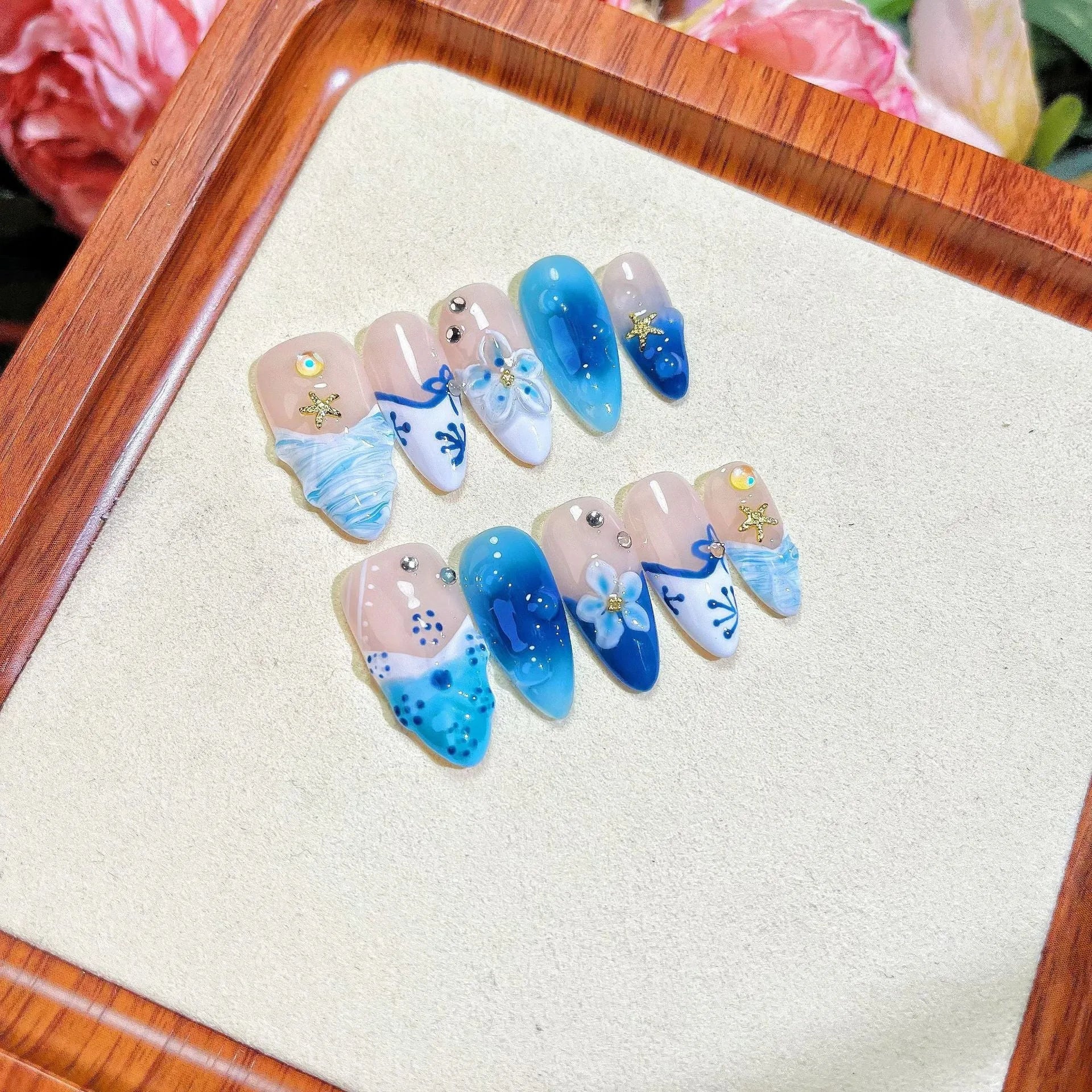 Blue hand-painted carved fake nails on transparent base with four size options
