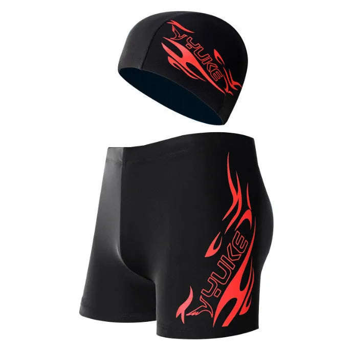 Men's red and blue fire pattern boxer swimming trunks with matching cap on black background.