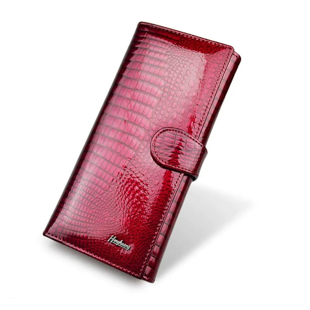 Women's red patent leather coin purse with a crocodile-embossed texture.