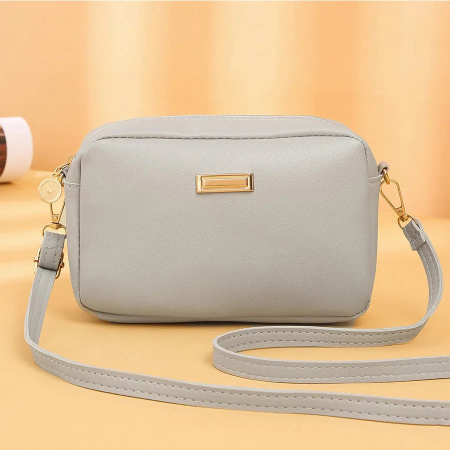 Women's PU shoulder bag in horizontal square shape with three-dimensional pocket, shown in solid colour options.