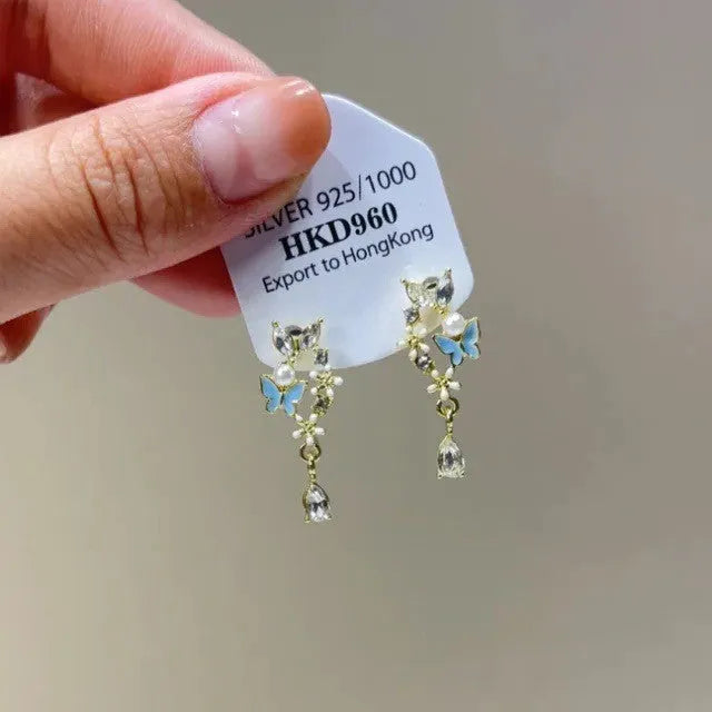 Women's geometric silver-tone alloy earrings with rhinestone star charms and tassel drops