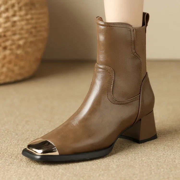 Brown high-heel Martin ankle boots with side zip and metal decoration on cowhide leather.