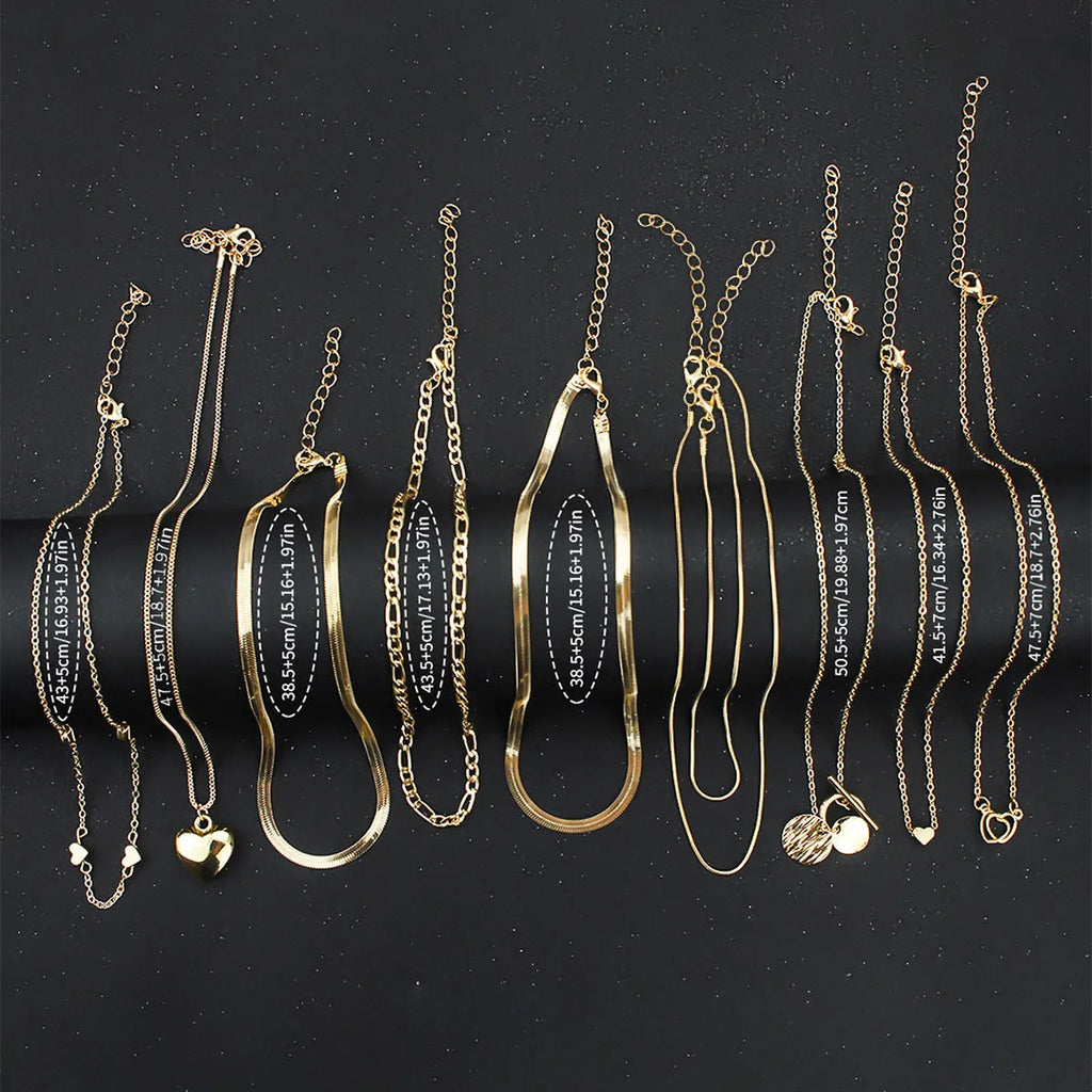 10 gold necklaces with snake bone chains and alloy pendants arranged in jewellery set